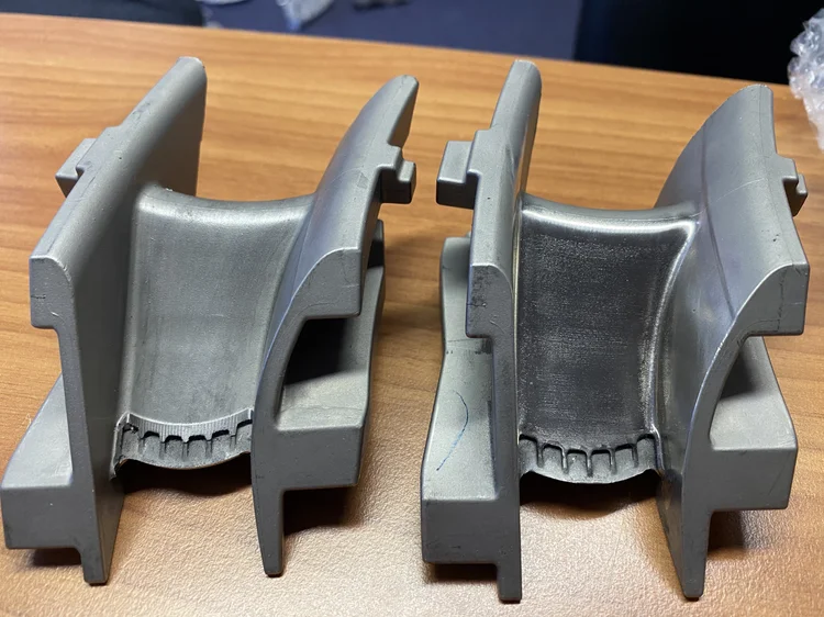 Precision cast metal components on a workbench